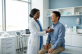 black nurse performing physical assessment